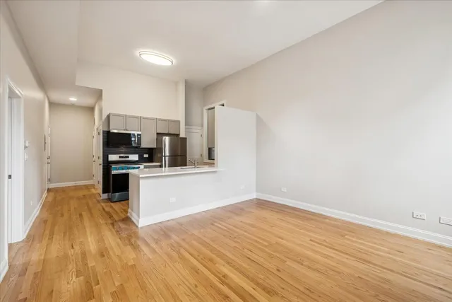 a view of kitchen with sink and refrigerator