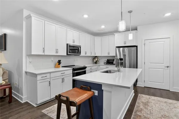 a kitchen with a refrigerator a stove a sink and a refrigerator
