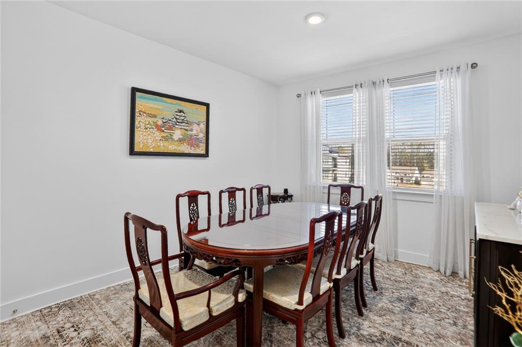 3321 Orwell Way, Unit 3402 Cumming, GA 30041 - Photo 13 of 30 a view of a dining room with furniture and a window