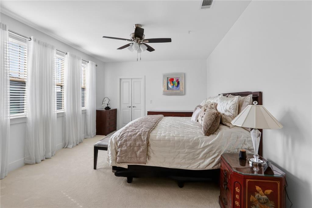 3321 Orwell Way, Unit 3402 Cumming, GA 30041 - Photo 14 of 30 a bedroom with a bed and ceiling fan