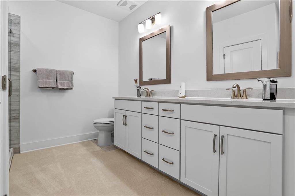 3321 Orwell Way, Unit 3402 Cumming, GA 30041 - Photo 15 of 30 a bathroom with a toilet sink and mirror