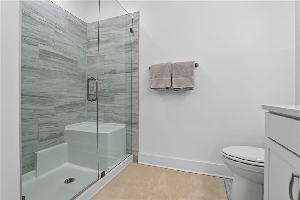 3321 Orwell Way, Unit 3402 Cumming, GA 30041 - Photo 16 of 30 a bathroom with a shower a toilet and sink