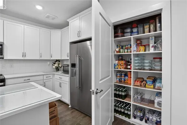 a kitchen with stainless steel appliances a refrigerator and cabinets