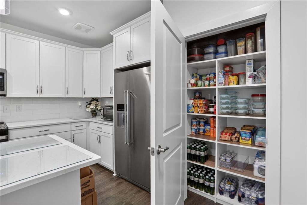 3321 Orwell Way, Unit 3402 Cumming, GA 30041 - Photo 6 of 30 a kitchen with stainless steel appliances a refrigerator and cabinets