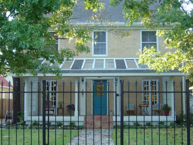 1402 Hartford Road Austin, TX 78703 - Photo 1 of 1 a view of a brick house with a large window and plants