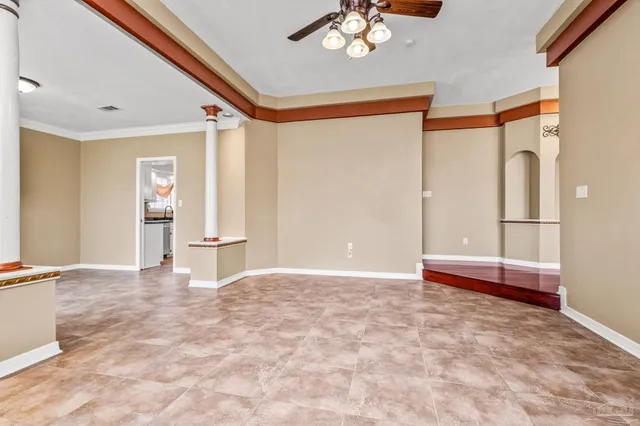 a view of an empty room with a window and a flat screen tv