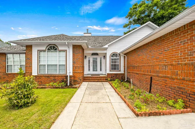 a front view of a house with a garden