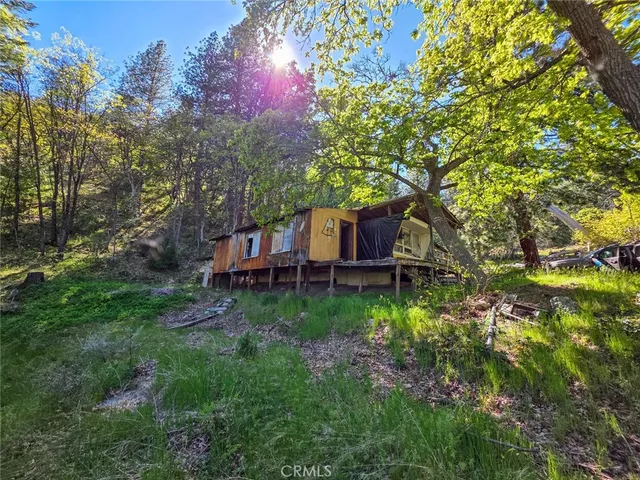 a view of a wooden house with a yard