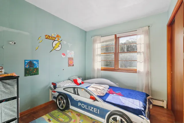 a kids bedroom with a bed and a window