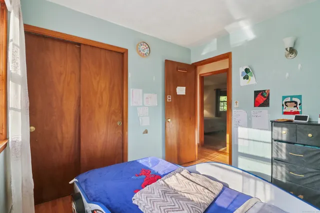 a bedroom with a bed and a dresser