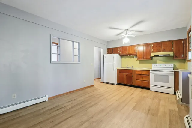 a kitchen with stainless steel appliances a refrigerator sink and cabinets