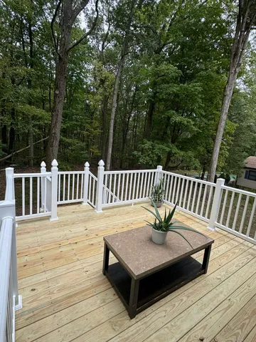 a view of a wooden deck with furniture