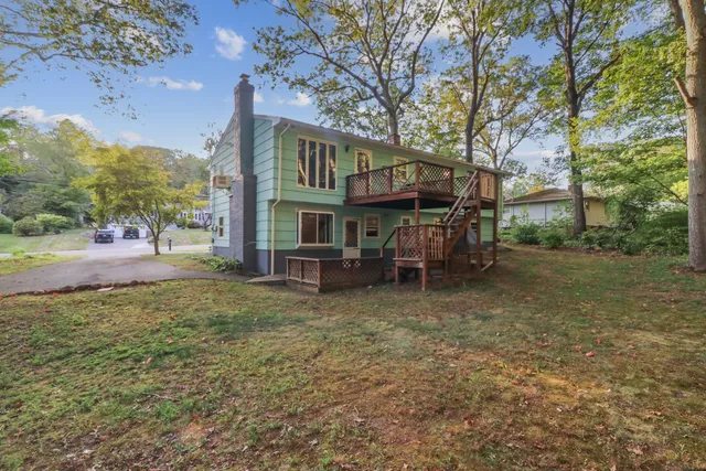 a view of a house with a yard porch and sitting area