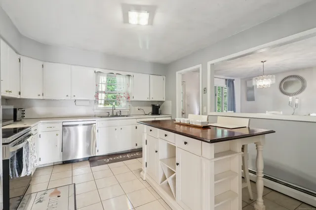 a kitchen with a sink window and cabinets