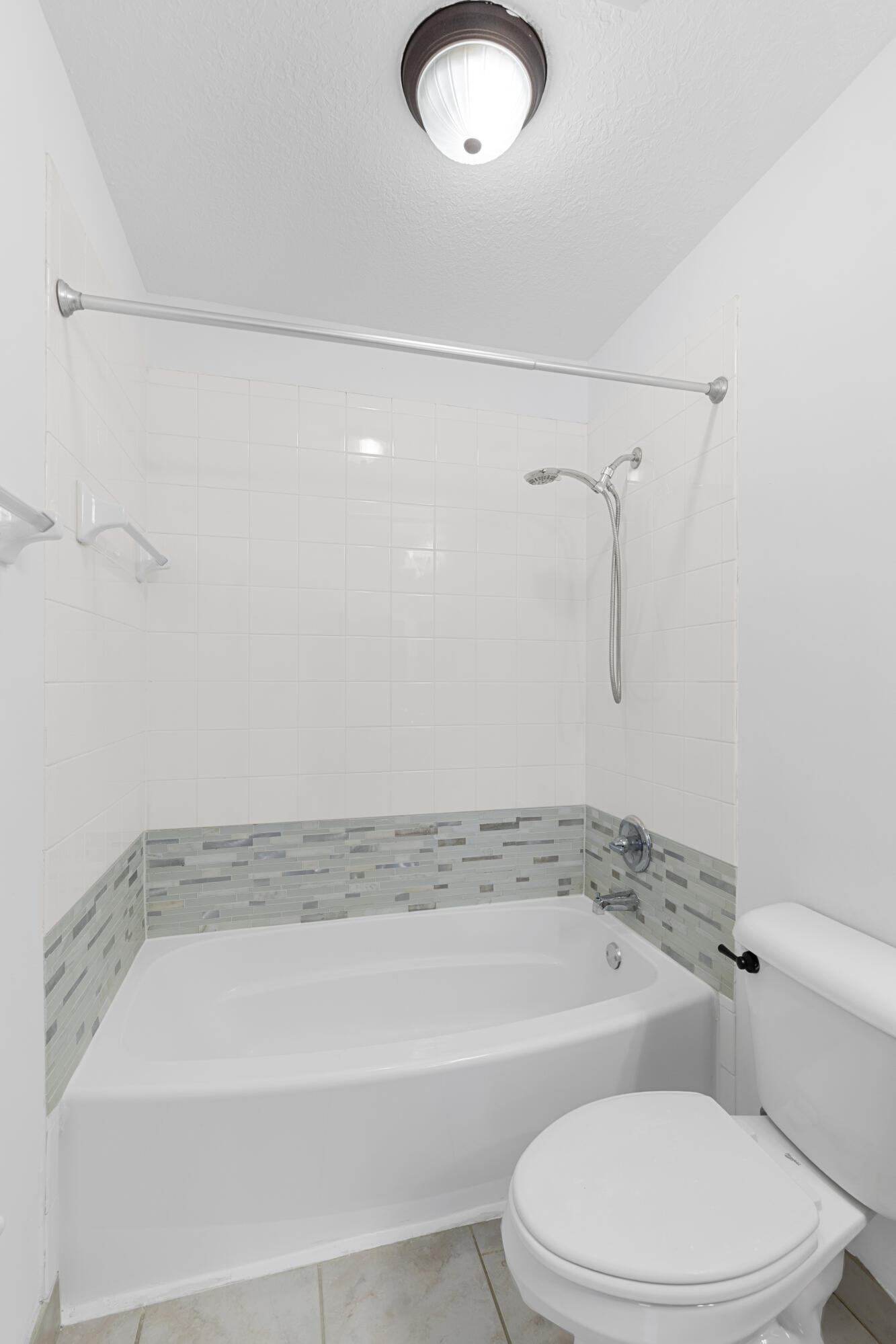 9107 Chambers Street, Unit 9107 Tamarac, FL 33321 - Photo 21 of 30 a bathroom with a toilet and a bath tub