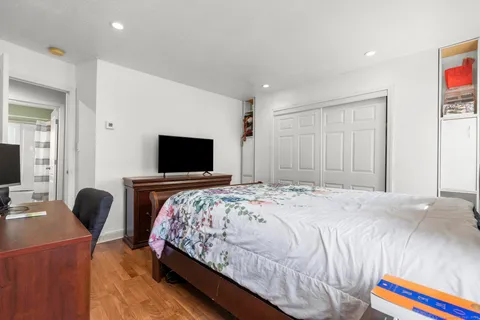 a bedroom with a bed and a flat screen tv