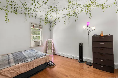 a bedroom with a bed and a window