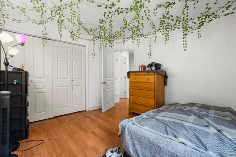 a bedroom with a bed and a chandelier