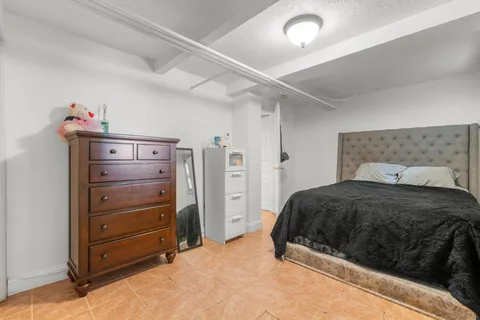 a bedroom with a bed and a dresser