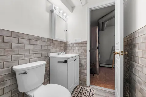 a bathroom with a toilet and a shower