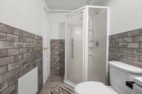 a bathroom with a toilet and shower