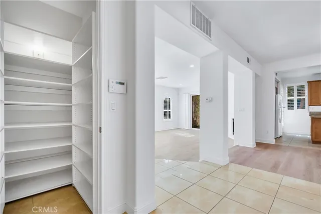 a view of a kitchen with a stove cabinets a ceiling fan and wooden floor