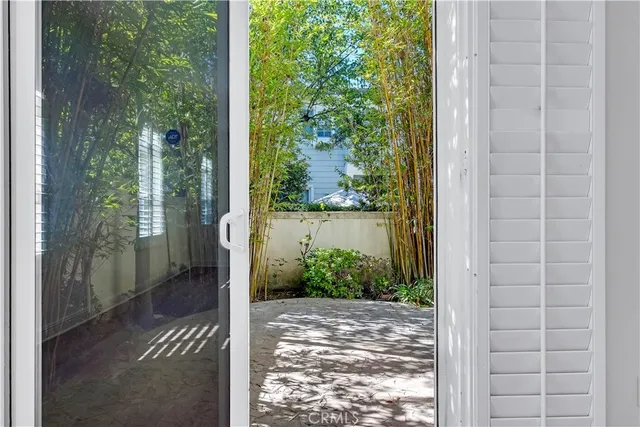 a kitchen with granite countertop a sink cabinets stainless steel appliances and a window