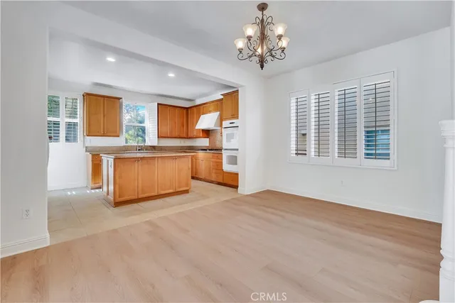a kitchen with stainless steel appliances granite countertop a refrigerator and wooden cabinets