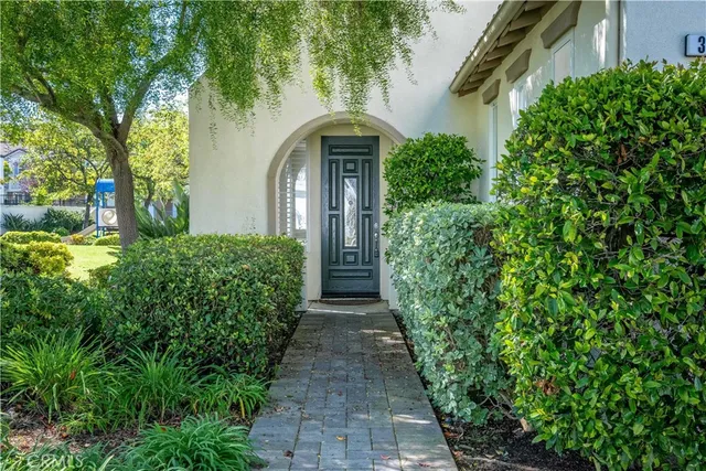 a front view of a house with lots of green space