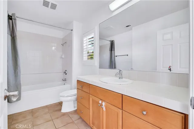 a spacious bathroom with a shower sink and mirror