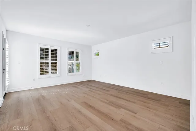 a bathroom with a granite countertop sink a toilet a mirror and bathtub