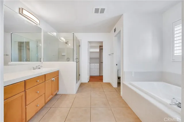 a view of a backyard with plants and large trees