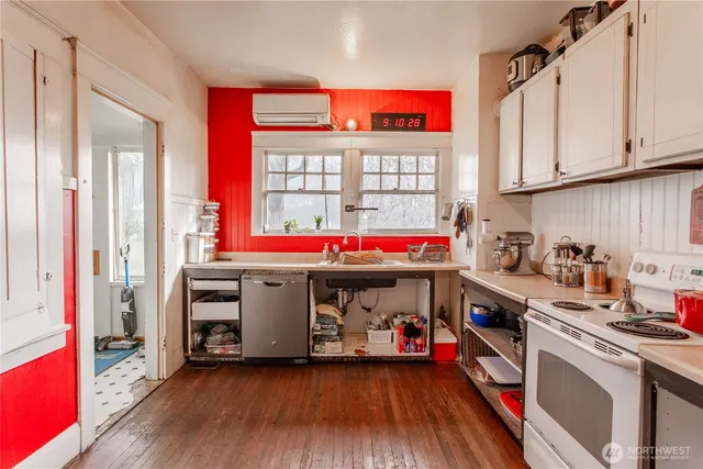 a view of utility room with wooden floor and windows