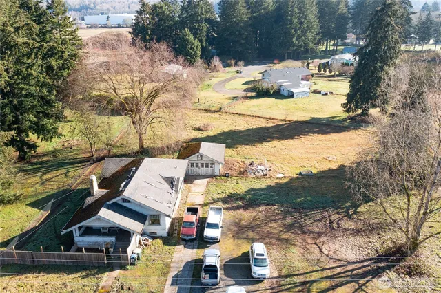 a view of a houses with yard and houses