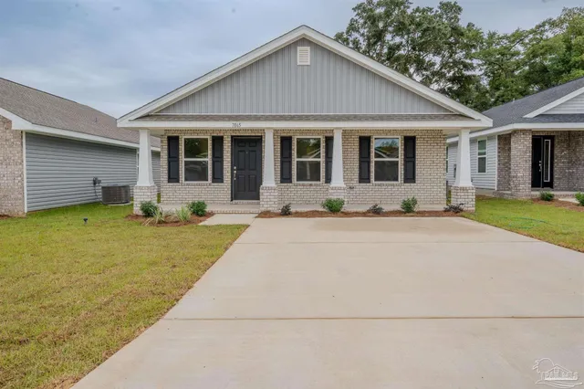a front view of a house with a yard and porch