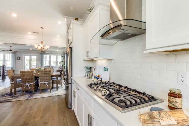 21 Pleasant St Inlet Beach Inlet Beach, FL 32461 - Photo 8 of 27 a kitchen with stainless steel appliances granite countertop a stove and a view of living room