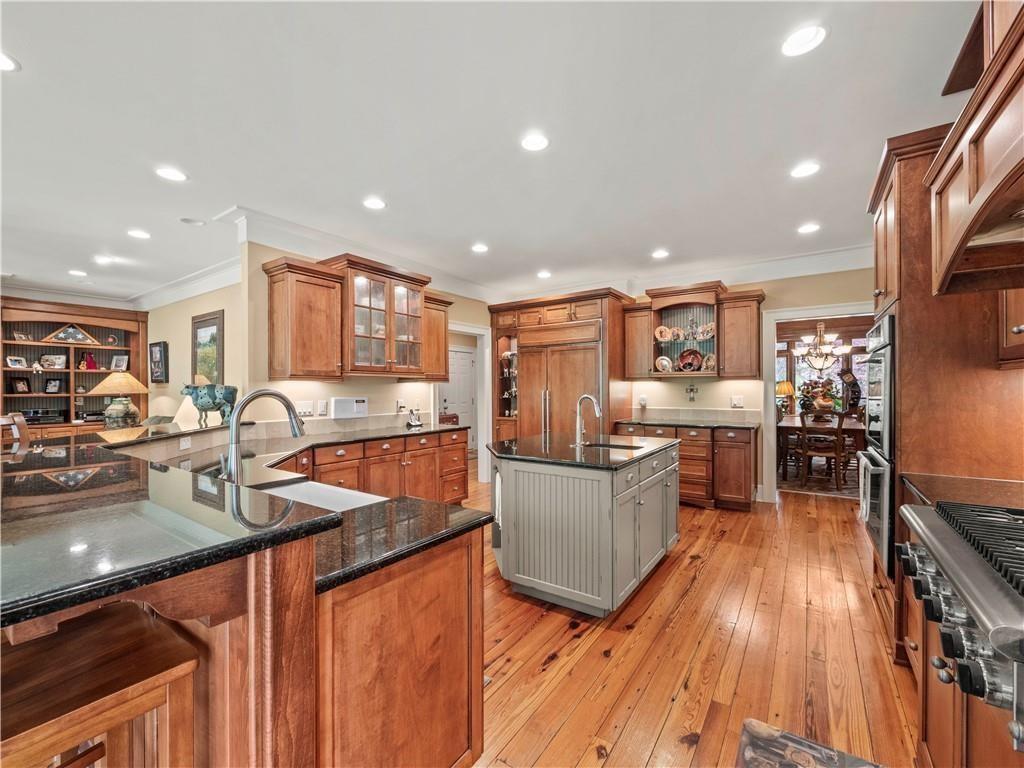 594 Peachtree Road Hoschton, GA 30548 - Photo 23 of 96 a kitchen with stainless steel appliances granite countertop sink stove top oven and cabinets
