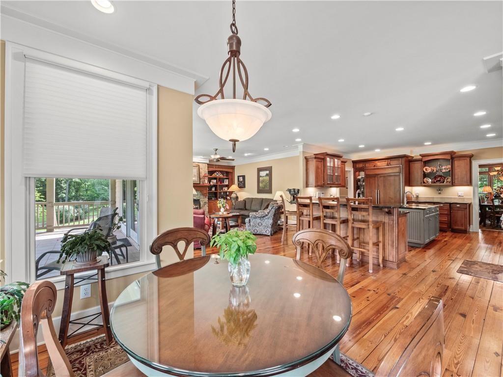 594 Peachtree Road Hoschton, GA 30548 - Photo 27 of 96 a view of a dining room and livingroom with furniture wooden floor a chandelier