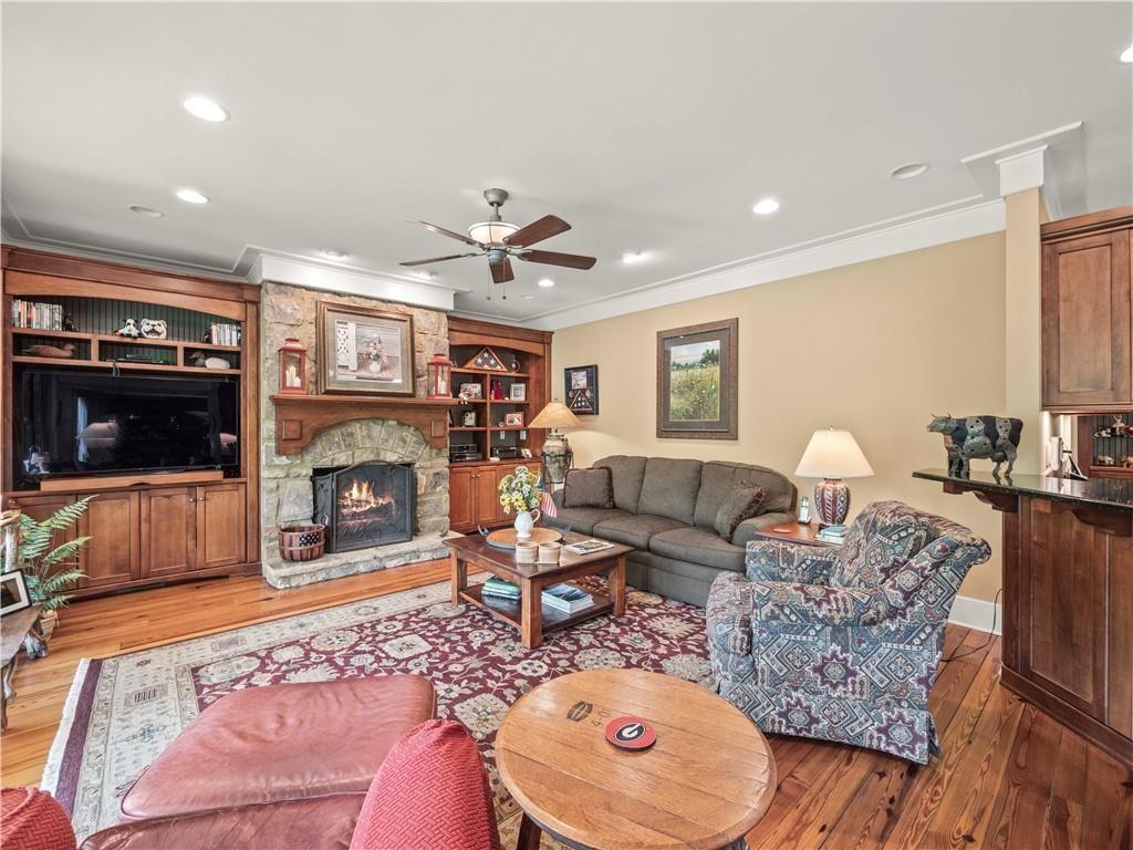 594 Peachtree Road Hoschton, GA 30548 - Photo 28 of 96 a living room with furniture a flat screen tv and a fireplace