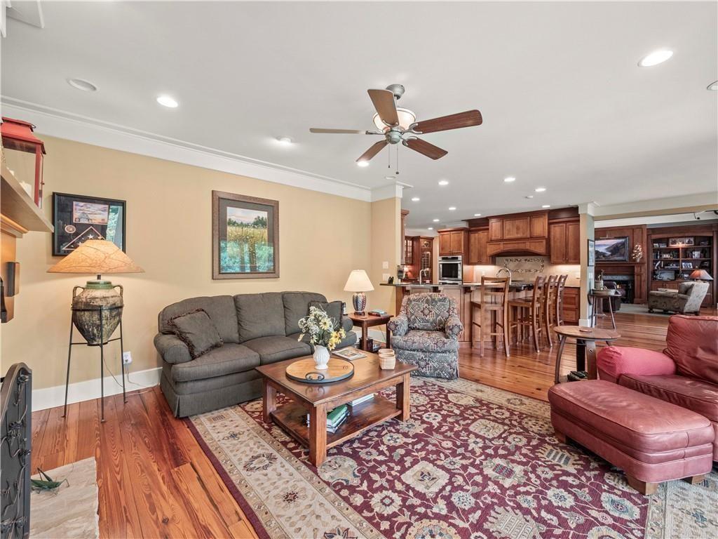 594 Peachtree Road Hoschton, GA 30548 - Photo 29 of 96 a living room with furniture kitchen view and a wooden floor