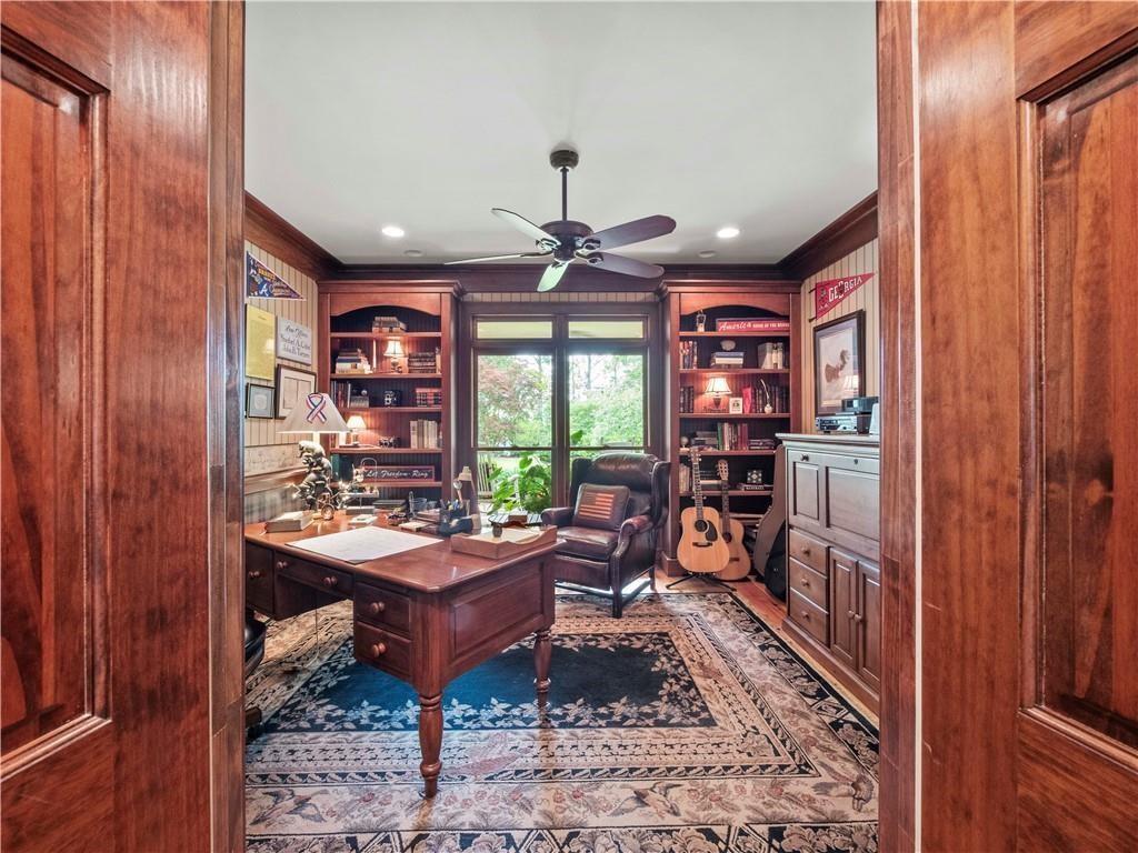 594 Peachtree Road Hoschton, GA 30548 - Photo 33 of 96 a living room with furniture a window and a bookshelf