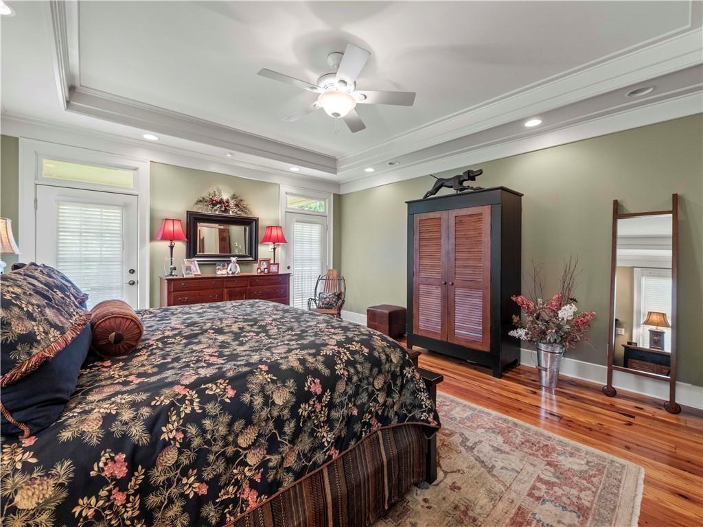 594 Peachtree Road Hoschton, GA 30548 - Photo 38 of 96 a bedroom with a large bed and a chandelier