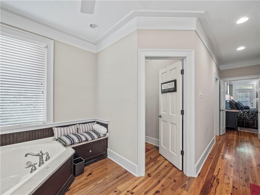 594 Peachtree Road Hoschton, GA 30548 - Photo 41 of 96 a view of a hallway with a bedroom and wooden floor
