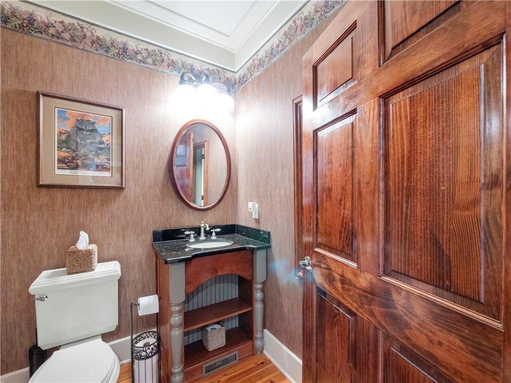 594 Peachtree Road Hoschton, GA 30548 - Photo 48 of 96 a bathroom with a toilet a sink and a shower curtain