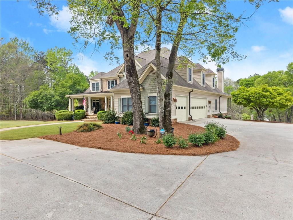 594 Peachtree Road Hoschton, GA 30548 - Photo 5 of 96 a view of a house with a backyard and a tree