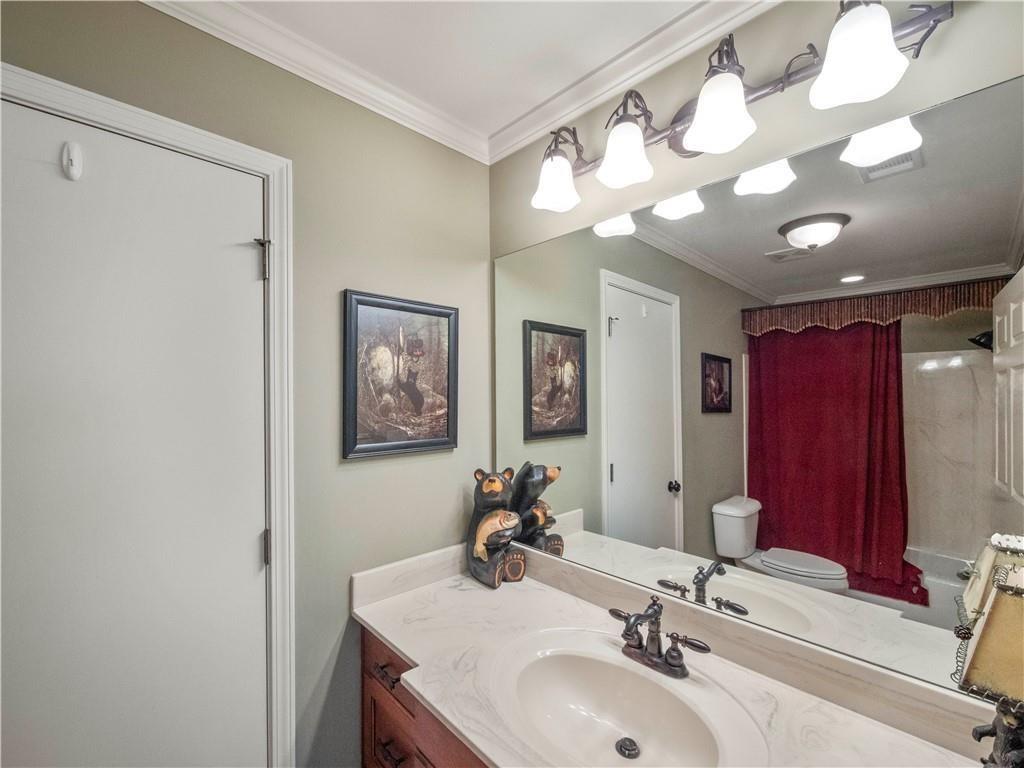 594 Peachtree Road Hoschton, GA 30548 - Photo 54 of 96 a bathroom with a sink and a mirror