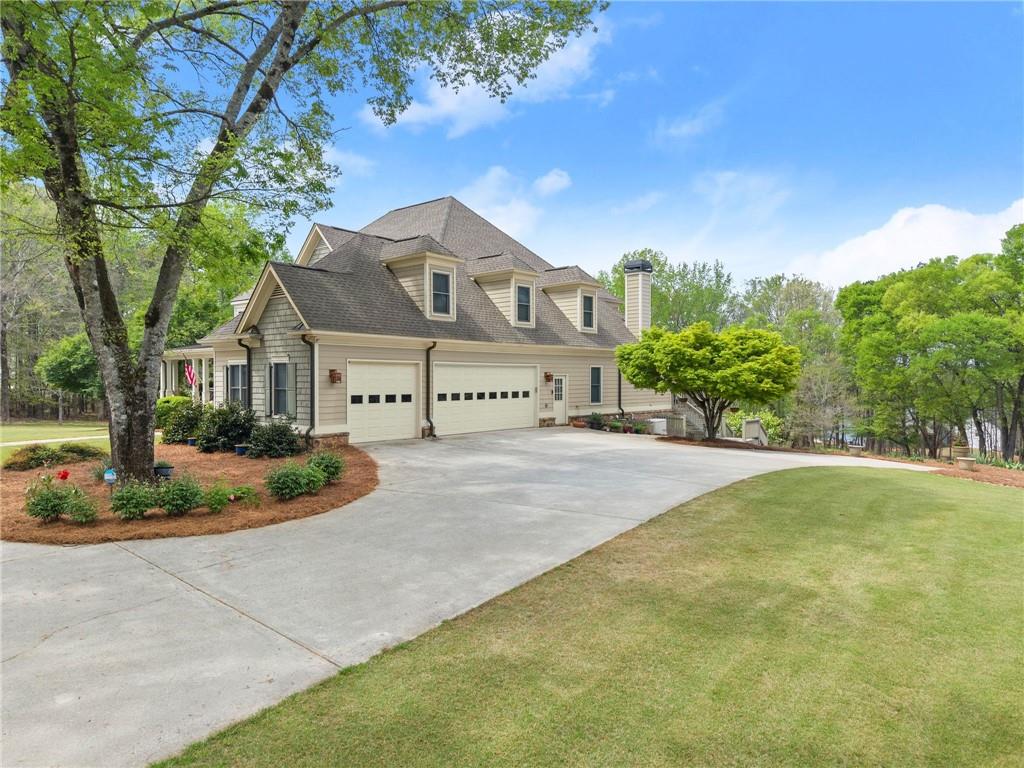 594 Peachtree Road Hoschton, GA 30548 - Photo 6 of 96 a front view of a house with a yard and garage