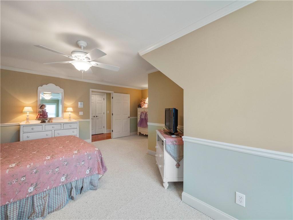 594 Peachtree Road Hoschton, GA 30548 - Photo 61 of 96 a spacious bedroom with a bed dresser and a window