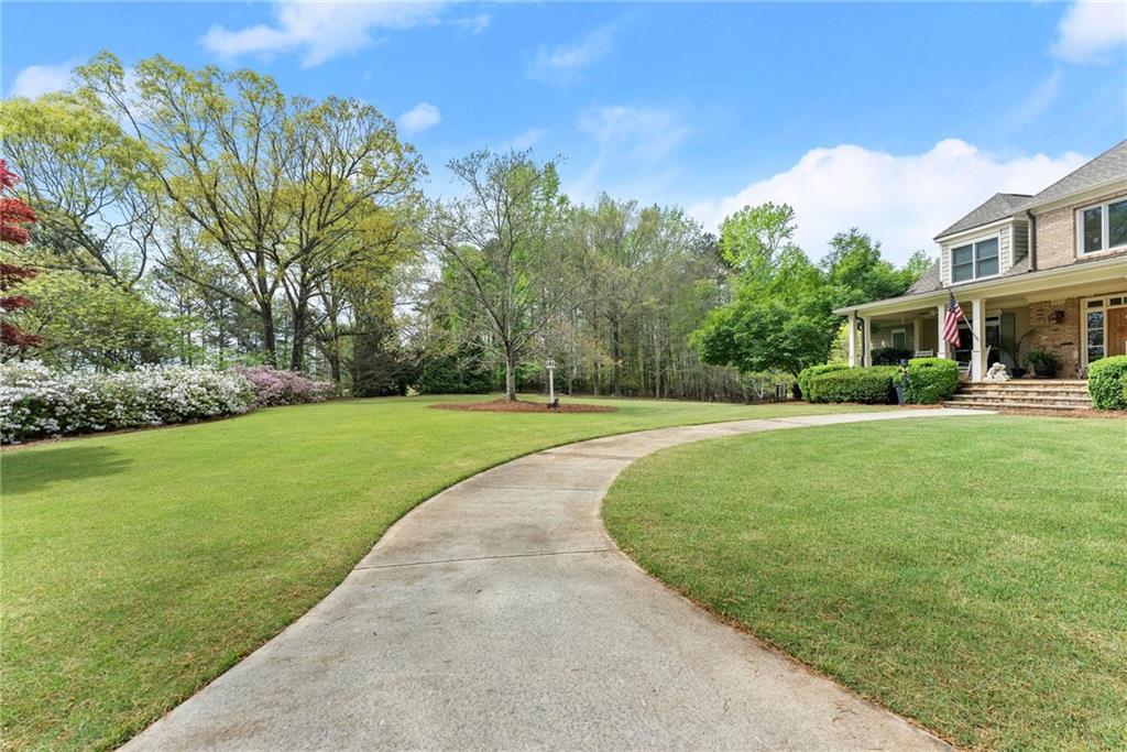 594 Peachtree Road Hoschton, GA 30548 - Photo 8 of 96 a view of a house with a big yard