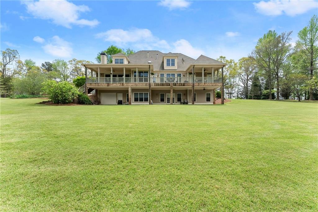 594 Peachtree Road Hoschton, GA 30548 - Photo 84 of 96 a view of a big room with a big yard and large trees
